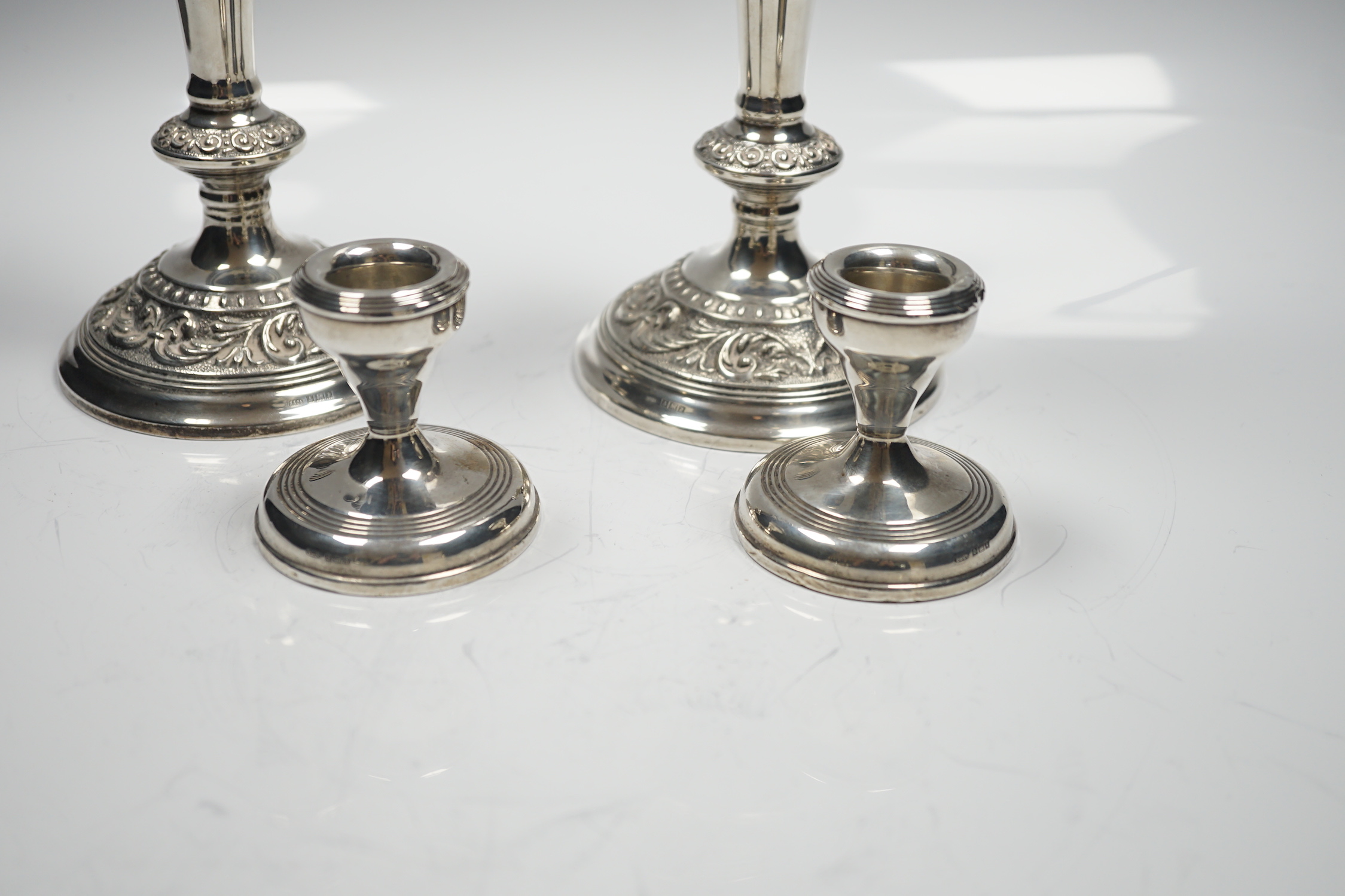 A modern pair of silver mounted candlesticks, Broadway & Co, Birmingham, 1991, 22.23cm and a pair of silver mounted dwarf candlesticks.